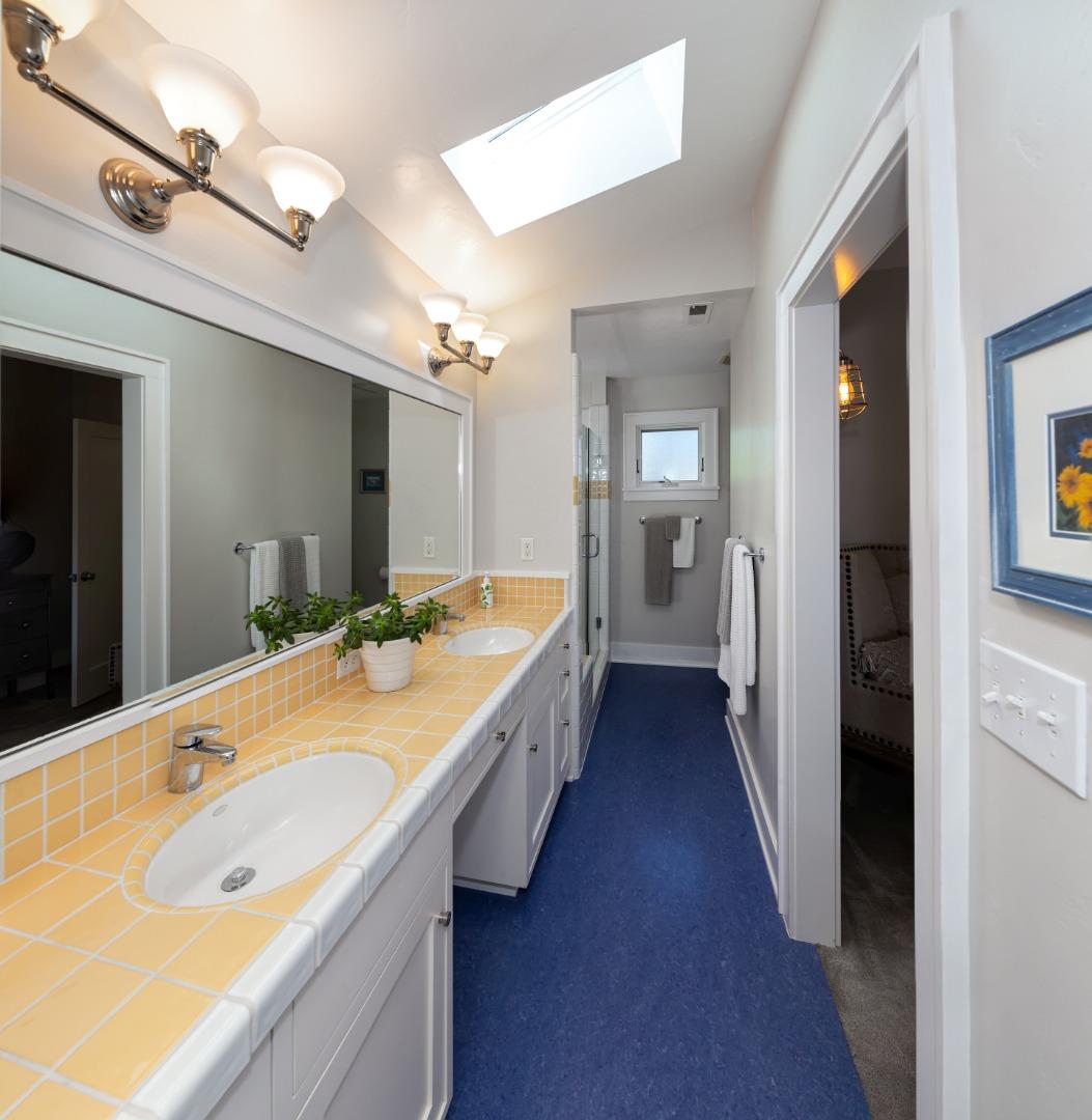 402 Riverview Avenue Capitola, CA 95010 - Photo 13 of 19 a bathroom with a granite countertop sink and a large mirror