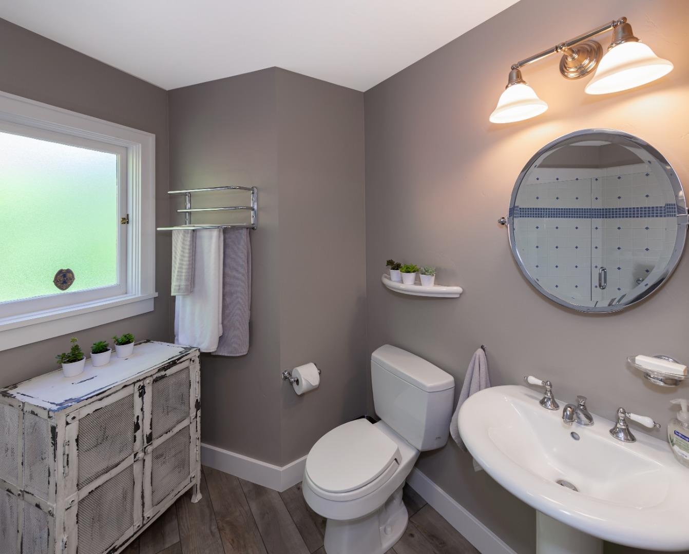 402 Riverview Avenue Capitola, CA 95010 - Photo 10 of 19 a bathroom with a toilet a sink and a mirror