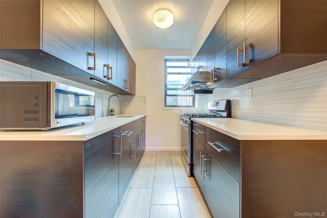 a kitchen with stainless steel appliances granite countertop a sink and a stove