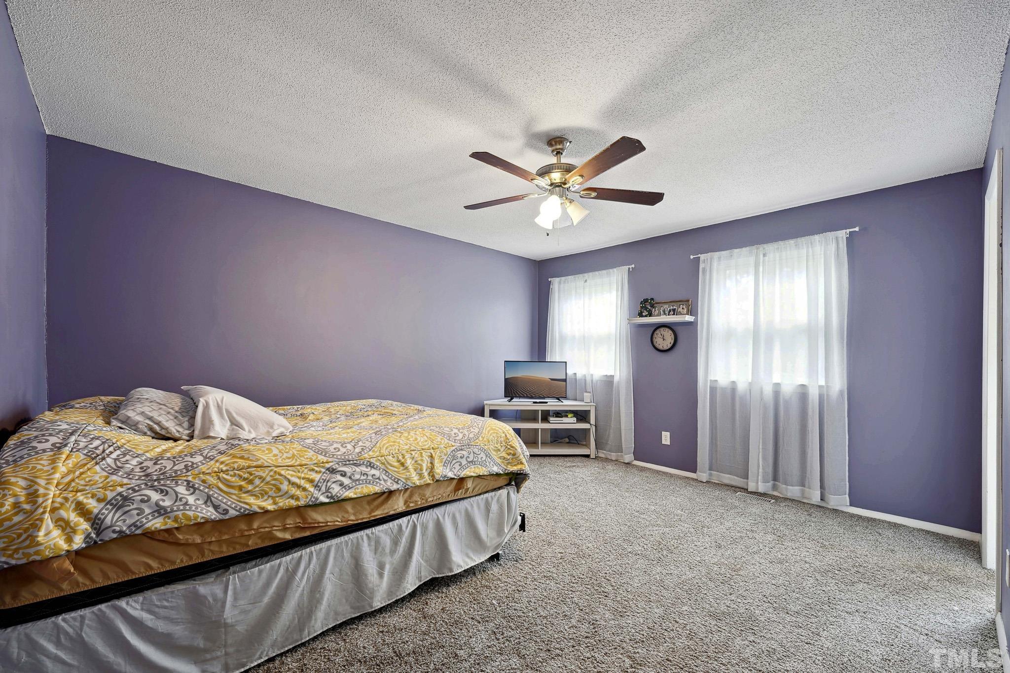 5809 Nottoway Court, Unit B Raleigh, NC 27609 - Photo 11 of 21 a bedroom with a bed and a chandelier