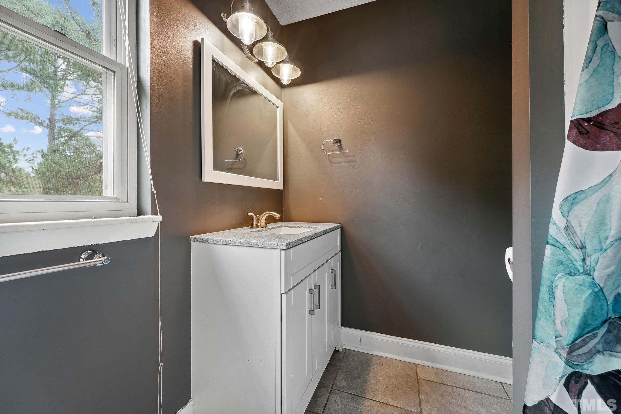 5809 Nottoway Court, Unit B Raleigh, NC 27609 - Photo 13 of 21 a bathroom with a double vanity sink and mirror