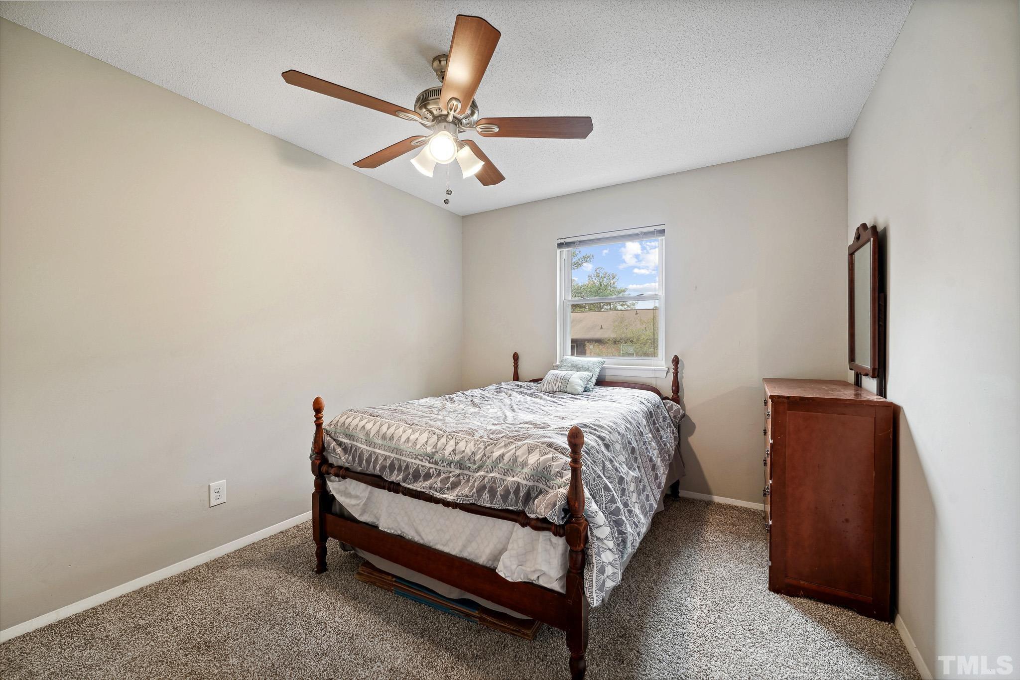 5809 Nottoway Court, Unit B Raleigh, NC 27609 - Photo 14 of 21 a bedroom with a bed and a chandelier