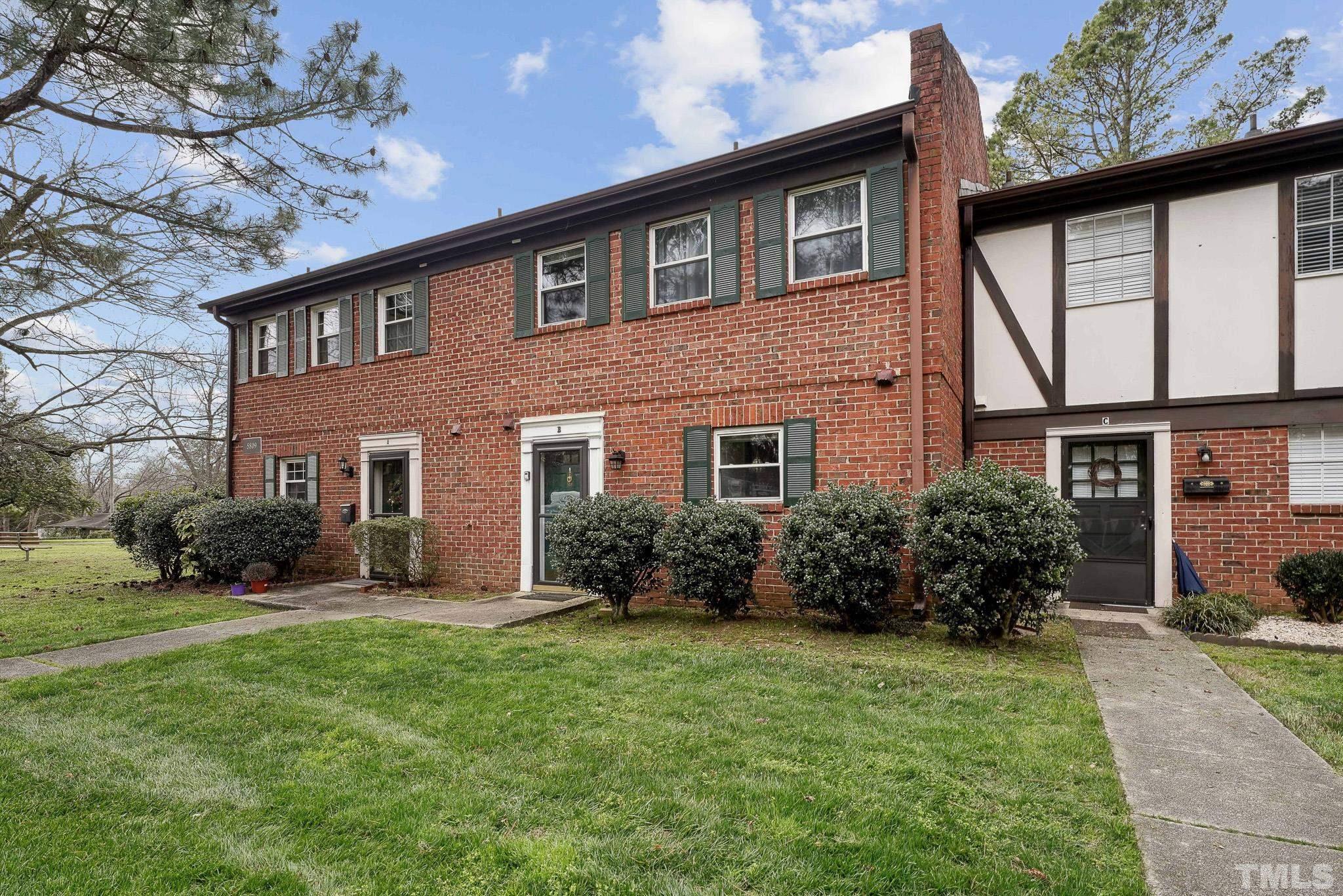 5809 Nottoway Court, Unit B Raleigh, NC 27609 - Photo 2 of 21 a front view of a house with a yard and garage