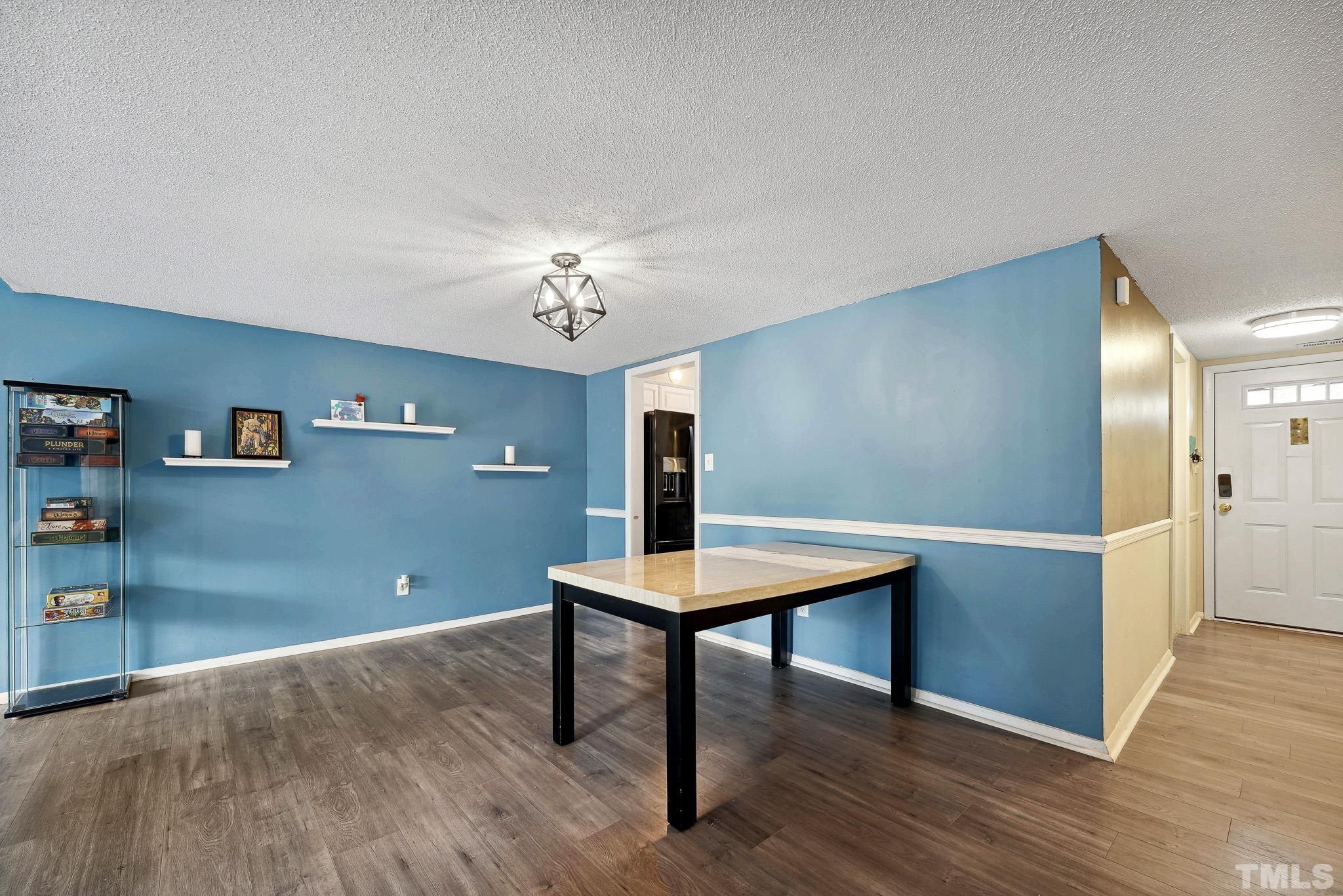 5809 Nottoway Court, Unit B Raleigh, NC 27609 - Photo 4 of 21 a view of a room with a table and chairs
