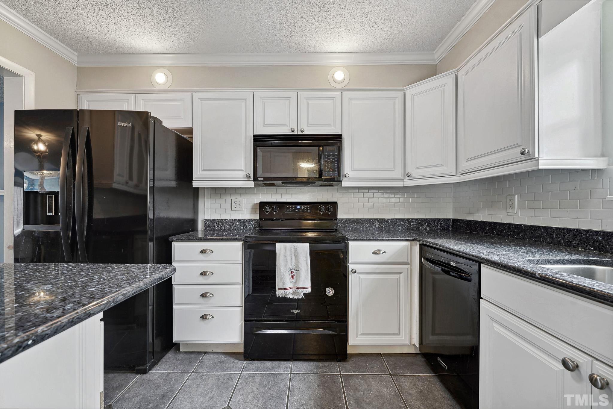 5809 Nottoway Court, Unit B Raleigh, NC 27609 - Photo 7 of 21 a kitchen with stainless steel appliances granite countertop a stove and a refrigerator
