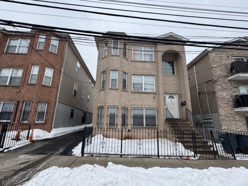 503 15th Avenue Newark, NJ 07103 - Photo 2 of 7 a view of a brick house with many windows