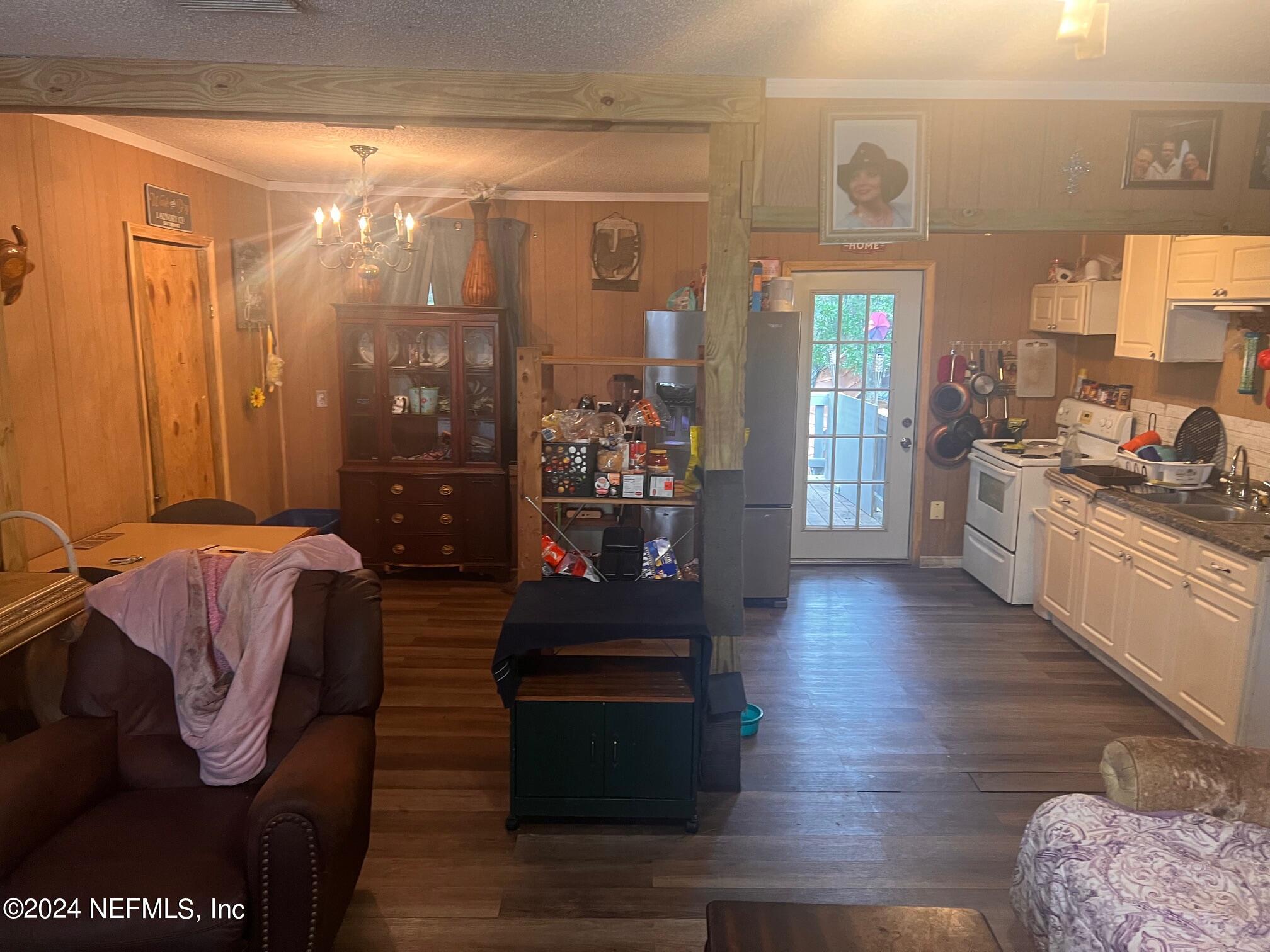 4203 Spring Park Road Jacksonville, FL 32207 - Photo 12 of 19 a living room with furniture and a floor to ceiling window