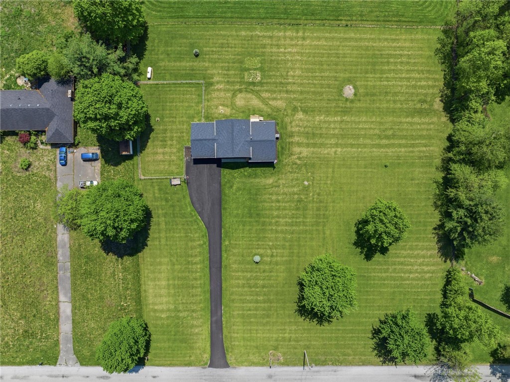 1353 Foust Road Xenia, OH 45385 - Photo 20 of 50 This aerial view showcases a residential property nestled within expansive, manicured green spaces.