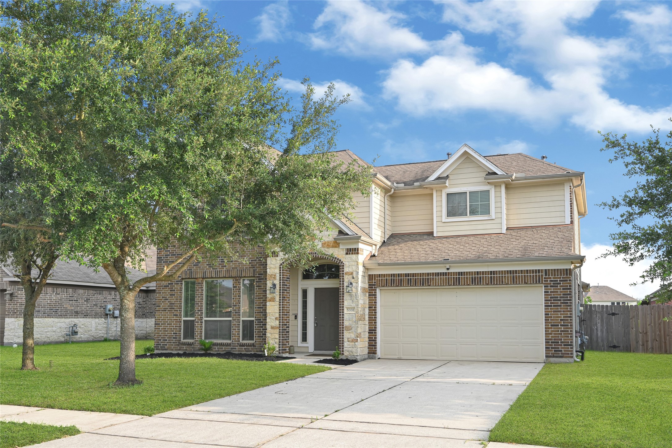 5331 Seabird Street Baytown, TX 77521 - Photo 2 of 38 a front view of a house with a garden