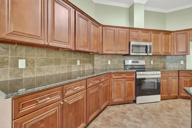 a kitchen with granite countertop a sink and a stove