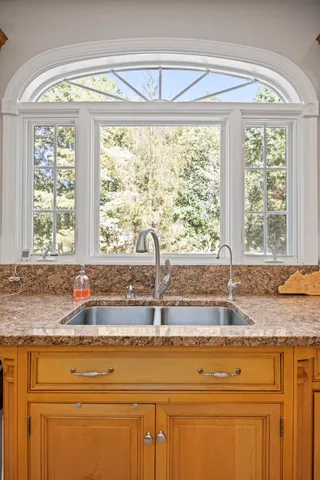 a stove top oven sitting inside of a kitchen