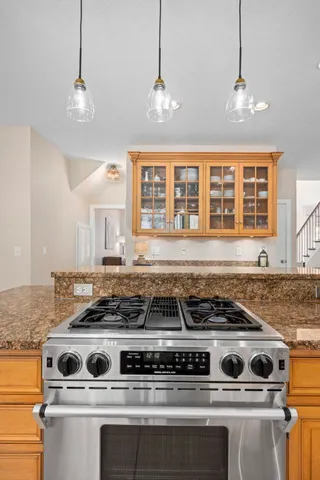 a dining room with furniture a chandelier and window