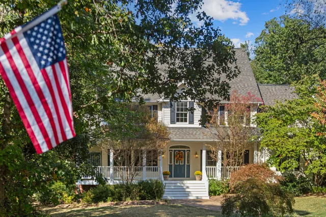 a front view of a multi story residential apartment building with a yard