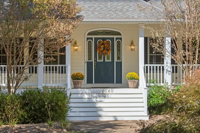 a front view of a house with a garden