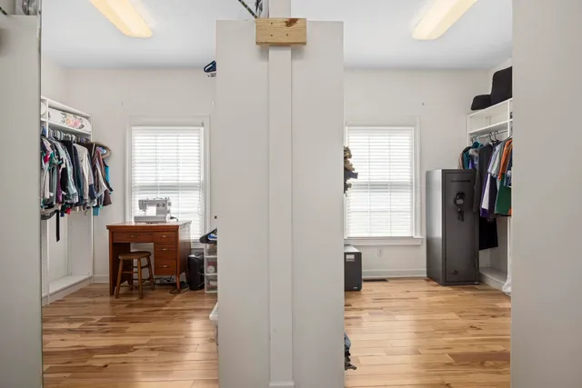 a utility room with a sink a toilet and a window