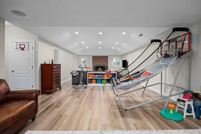 a view of a patio with couches table and chairs with wooden floor and fence