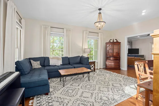 a living room with furniture a rug and a window