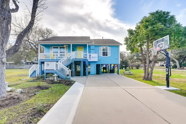 a front view of house with yard and green space
