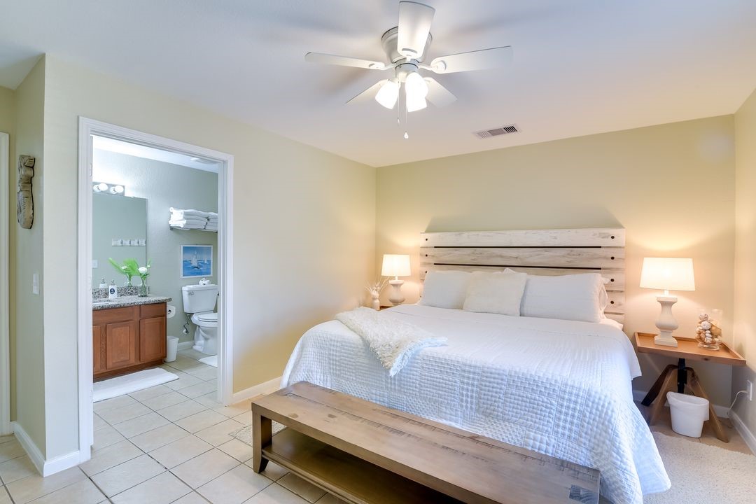 1206 4th Street Seabrook, TX 77586 - Photo 12 of 15 a bedroom with a large bed and chandelier
