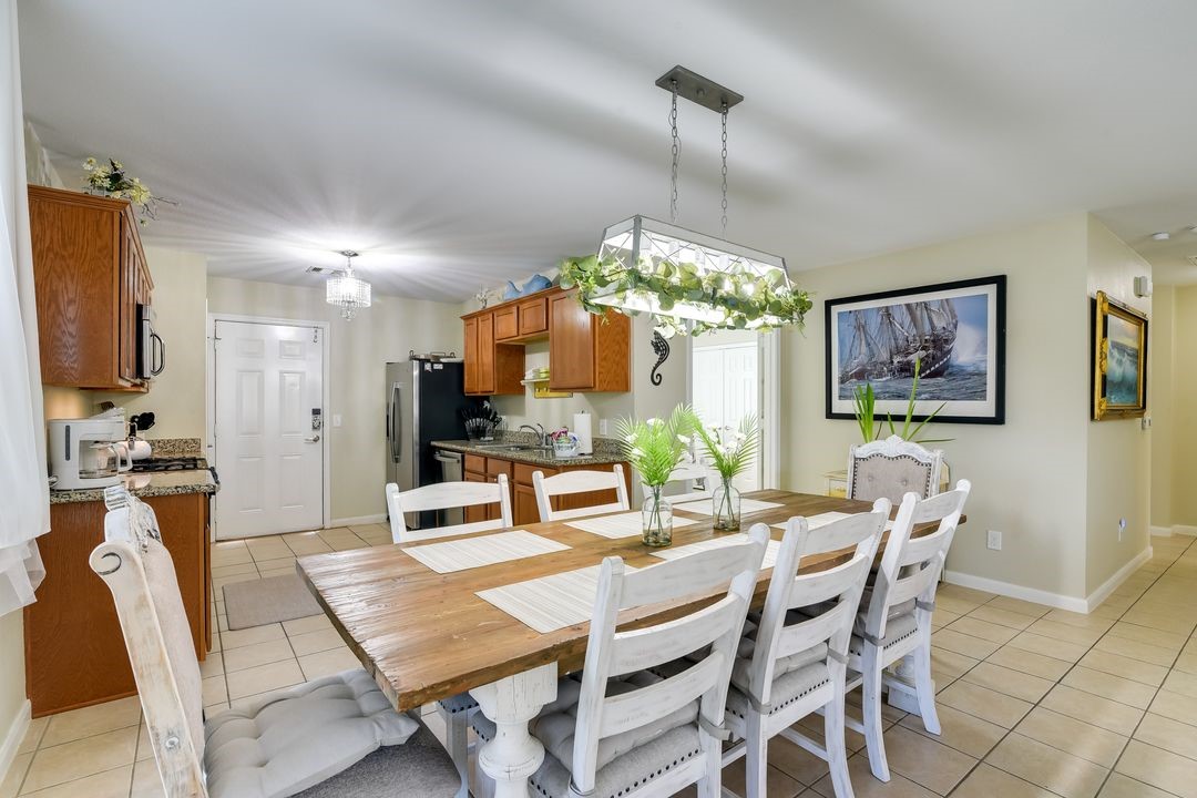 1206 4th Street Seabrook, TX 77586 - Photo 8 of 15 a view of a dining room with furniture a chandelier and wooden floor