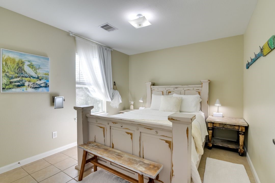 1206 4th Street Seabrook, TX 77586 - Photo 9 of 15 a bedroom with a bed and a table in it