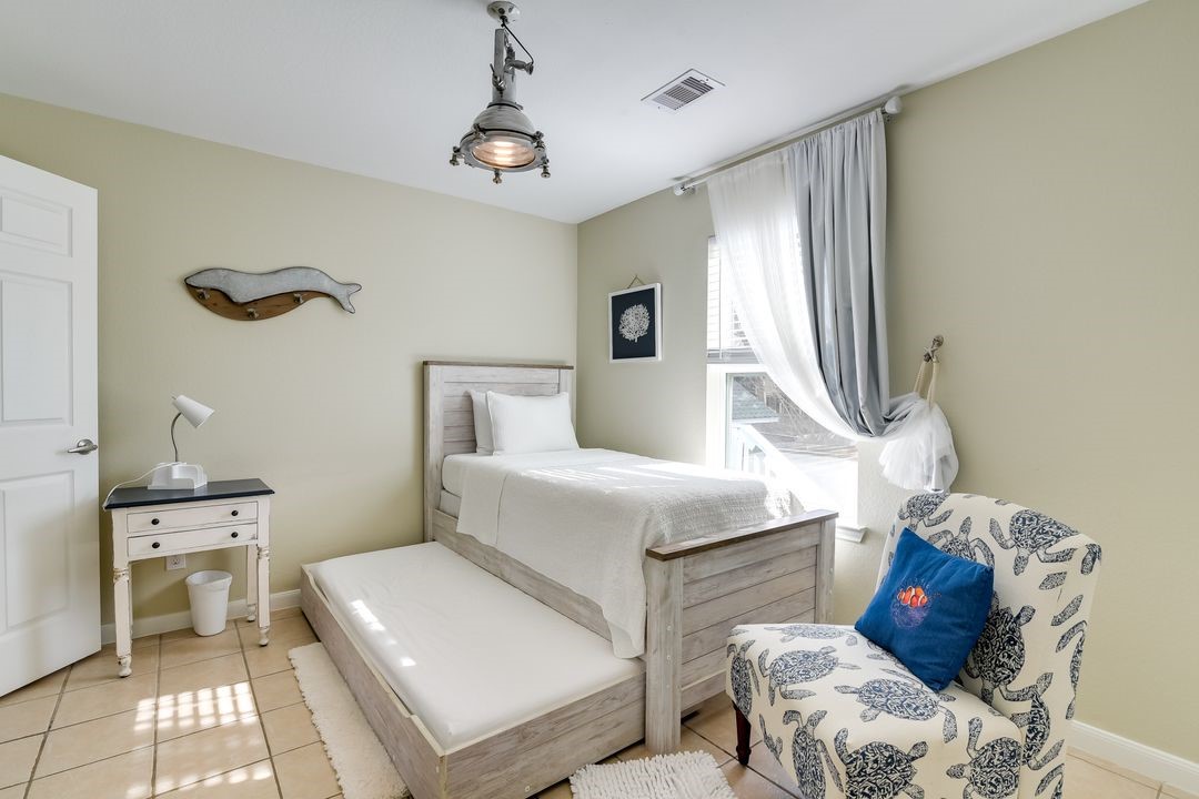 1206 4th Street Seabrook, TX 77586 - Photo 10 of 15 a bedroom with a bed and a chair