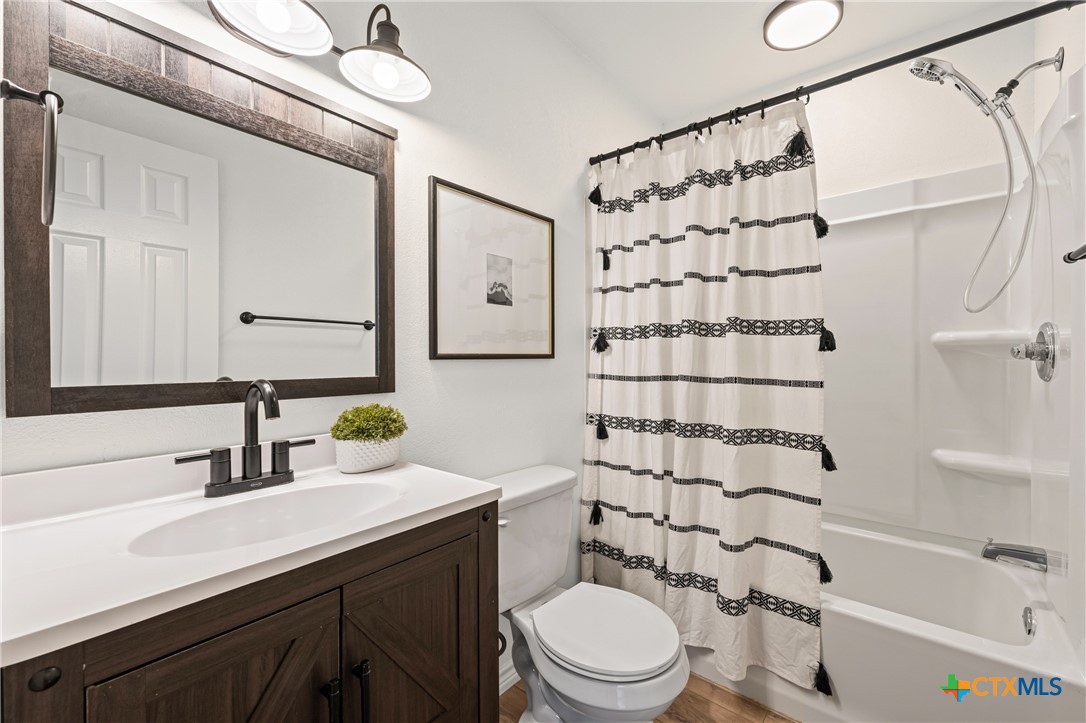 34 Golden Poppy Loop Belton, TX 76513 - Photo 14 of 27 a bathroom with a sink a toilet and shower