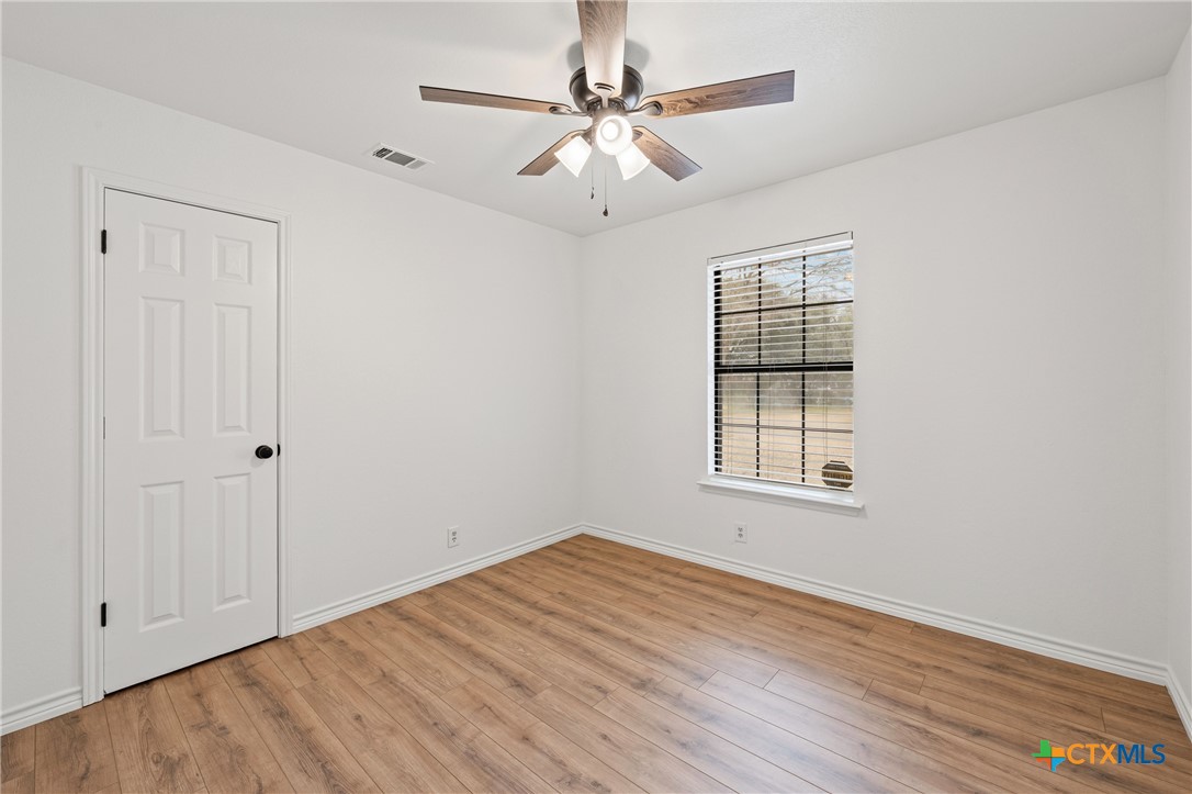 34 Golden Poppy Loop Belton, TX 76513 - Photo 15 of 27 a view of an empty room with window and wooden floor