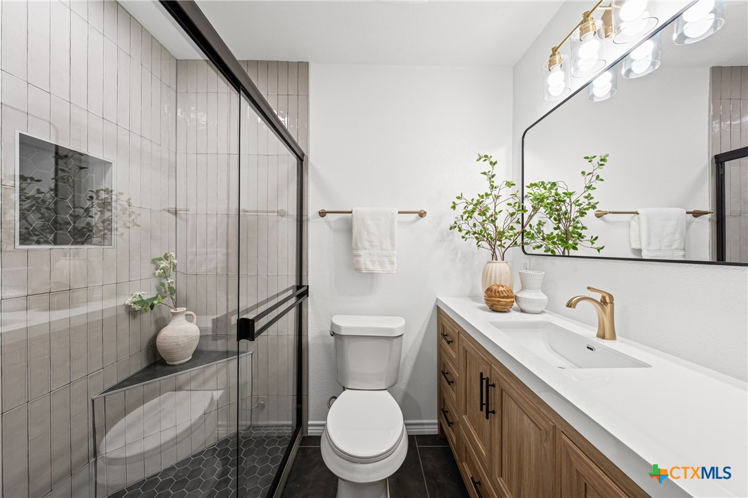 34 Golden Poppy Loop Belton, TX 76513 - Photo 19 of 27 a bathroom with a toilet sink and mirror