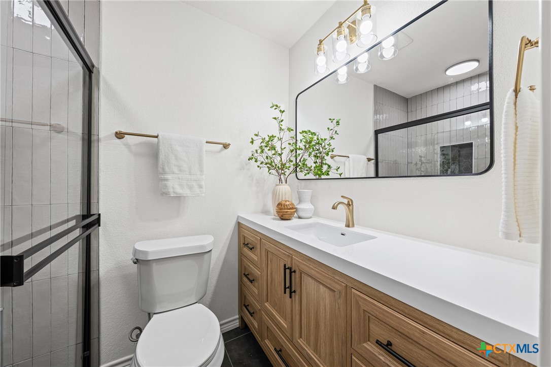 34 Golden Poppy Loop Belton, TX 76513 - Photo 20 of 27 a bathroom with a sink a toilet and mirror