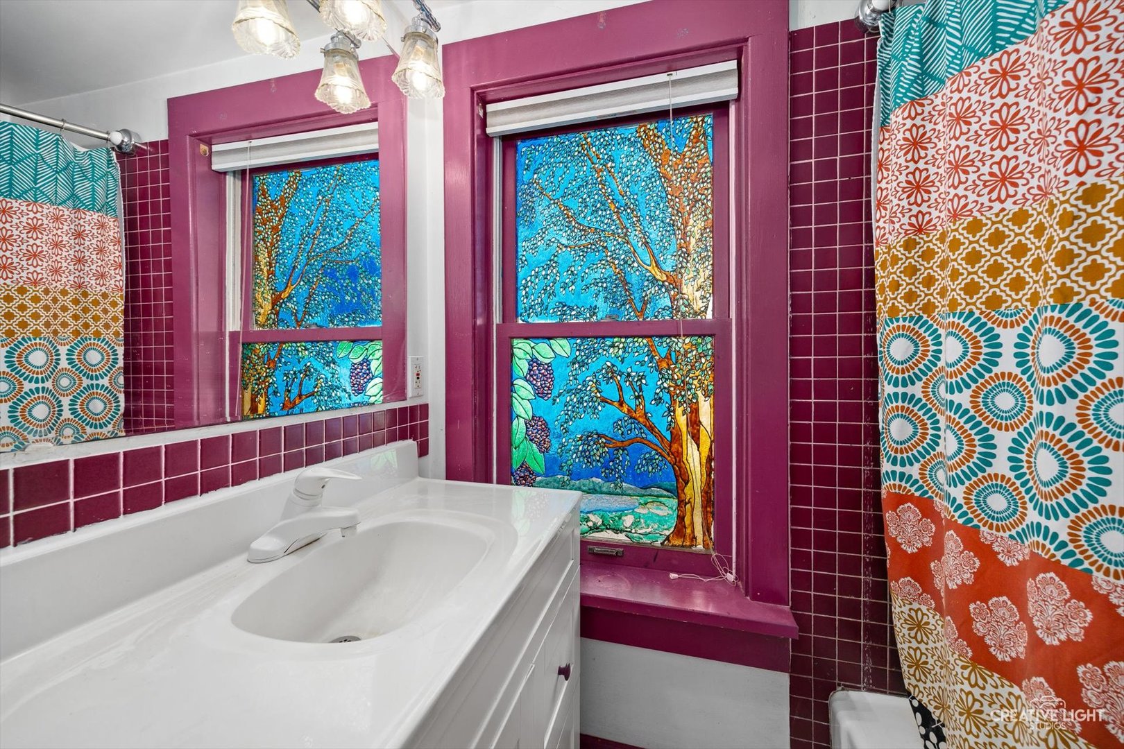 3S511 4th Street Warrenville, IL 60555 - Photo 12 of 36 a bathroom with a sink and a large mirror