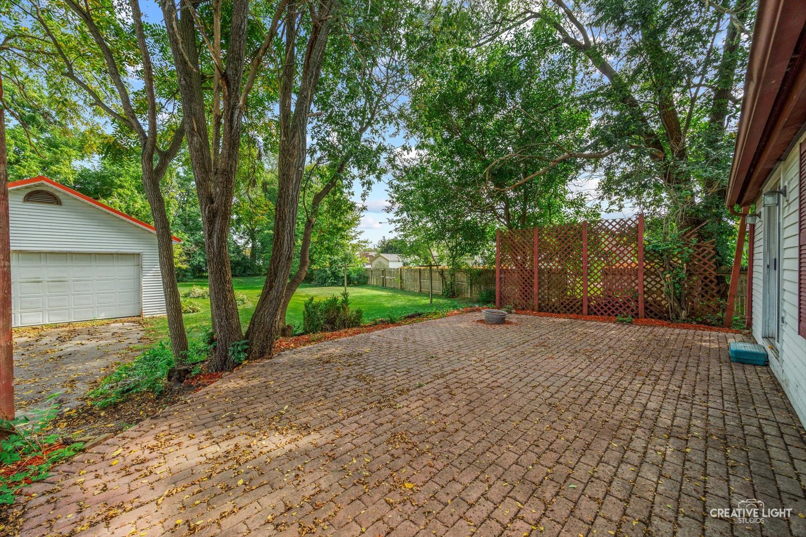 3S511 4th Street Warrenville, IL 60555 - Photo 13 of 36 a sidewalk with a trees and fence