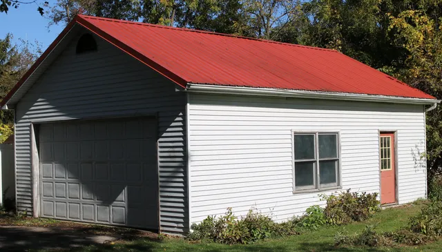 a front view of a house with plants
