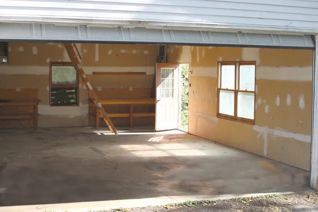 a view of an empty room with a fireplace