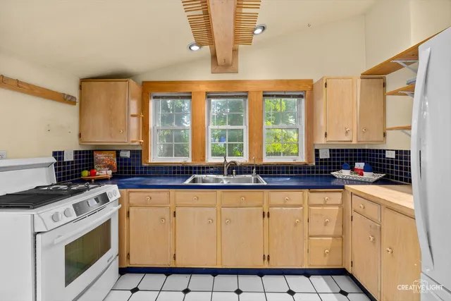 a kitchen with granite countertop white cabinets and white appliances