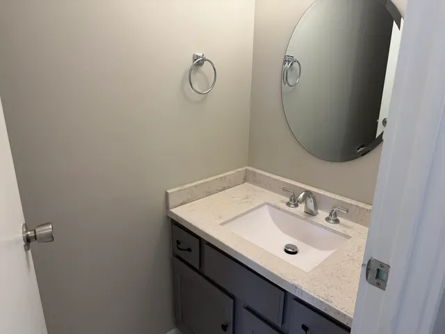 a bathroom with a sink and mirror