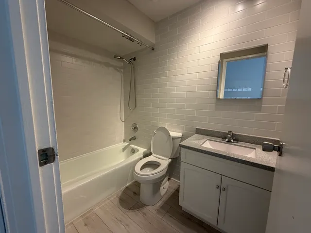 a bathroom with a sink toilet and shower