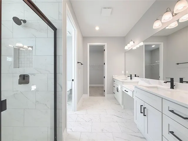 a bathroom with a double vanity sink and a mirror