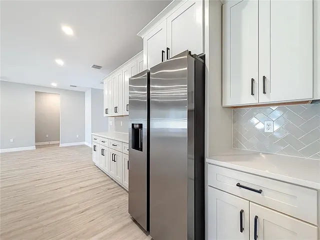 a large kitchen with stainless steel appliances lots of counter space sink and cabinets