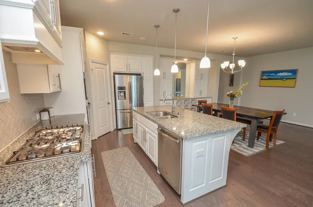 a kitchen with a stove and a table