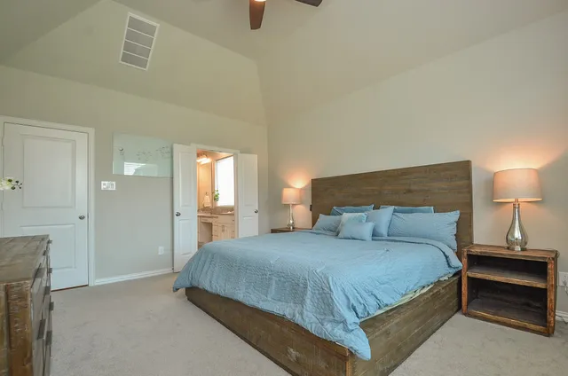 a bedroom with a bed and a night stand