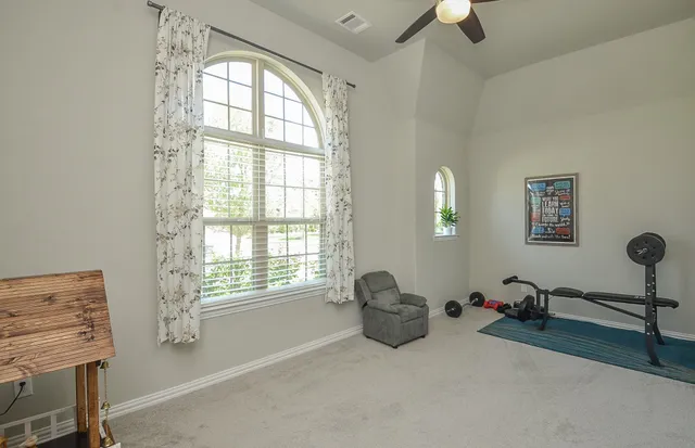 a bedroom with furniture and a window