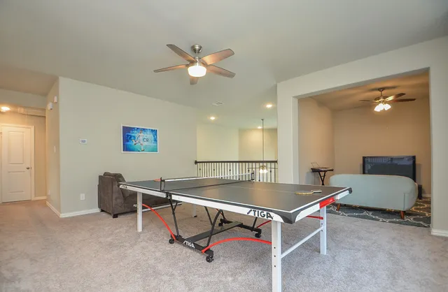 a living room with pool table and a couch