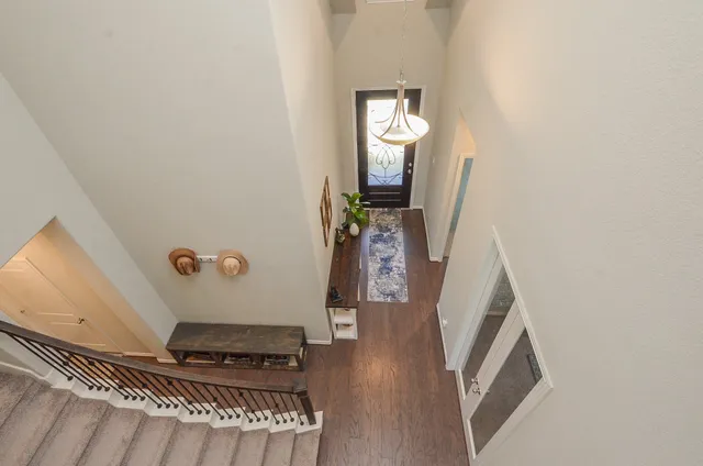 a view of a livingroom with wooden floor and stairs