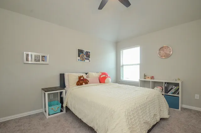 a bedroom with a bed and window