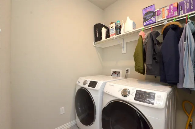 a view of a patio with a table and chairs and potted plants