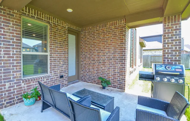 a view of a house with a yard and sitting area