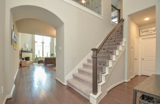 a view of entryway and hall with wooden floor