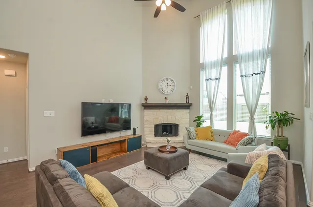 a living room with furniture wooden floor and a fireplace