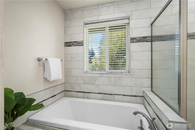 a bathroom with a bathtub and shower